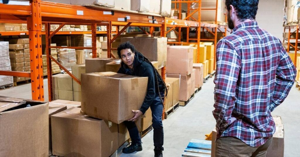 warehouse worker lifting large box