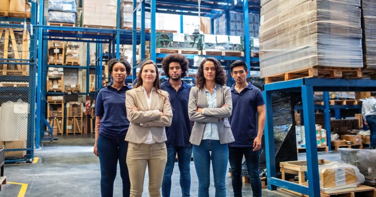 onsite staffing reps standing with employees in warehouse