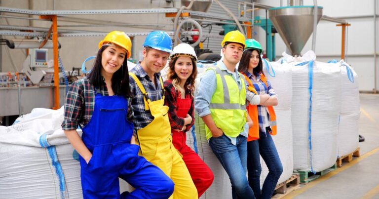 group of manufacturing workers looking at camera