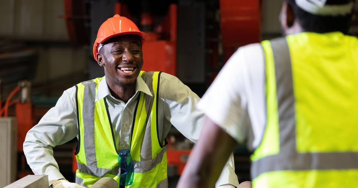 laughing employee talking to coworker in positive work environment