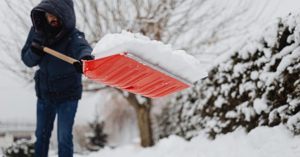 man shoveling snow winter weather
