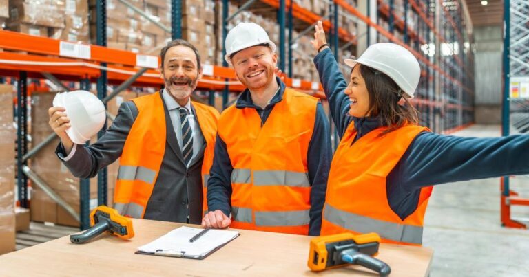 three warehouse workers acting friendly