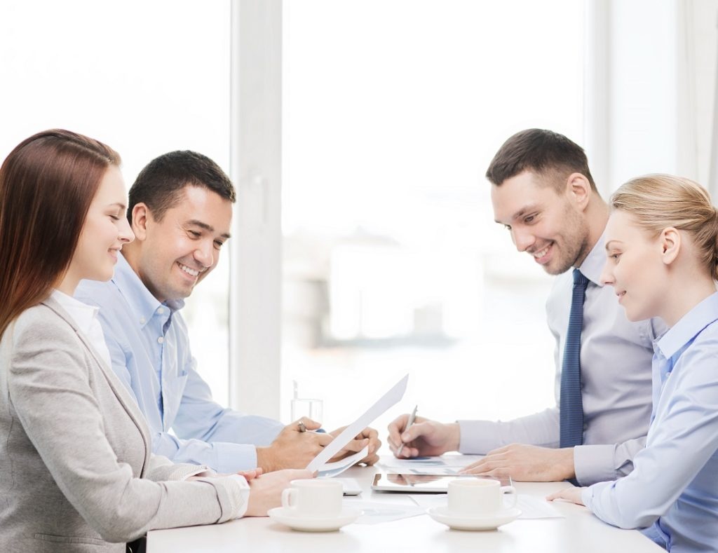 business and office concept - smiling business team having meeting in office