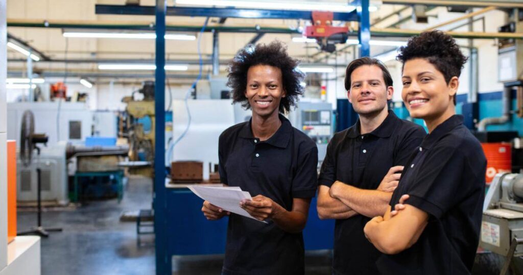 three smiling temporary employees on first day
