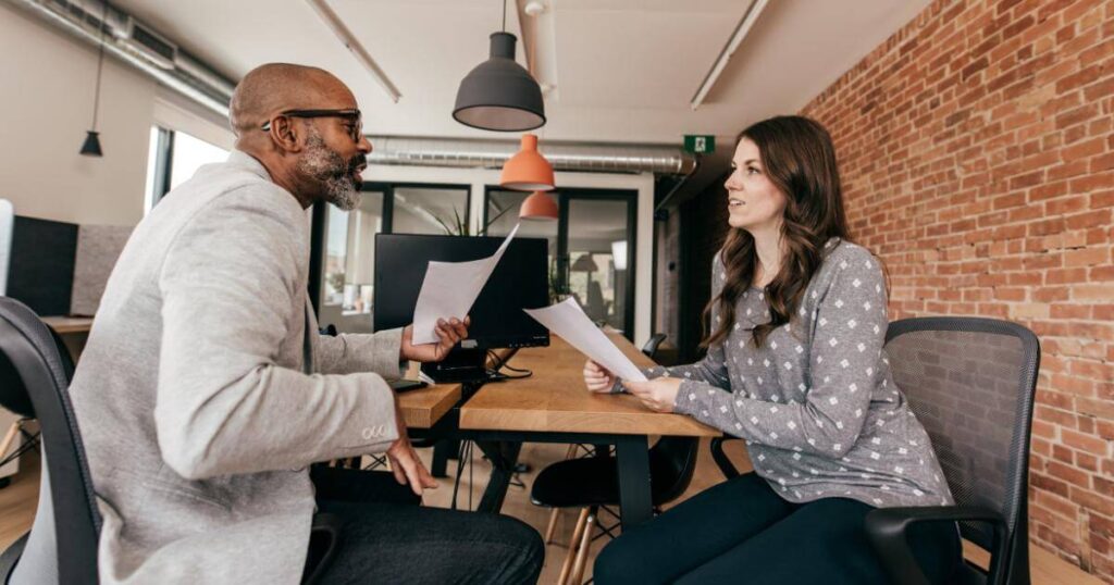 male and female colleague discussing employer brand