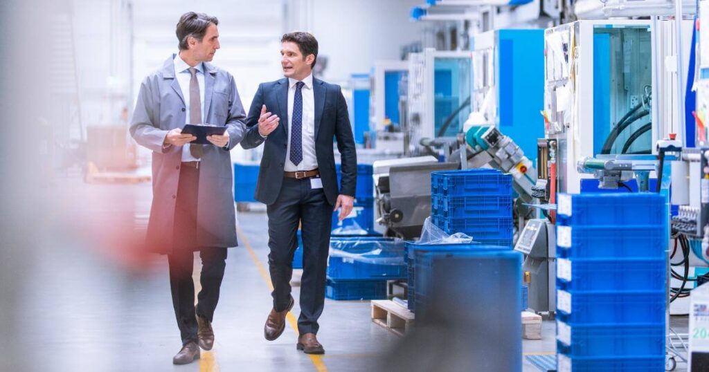 hiring manager walking production floor with staffing partner